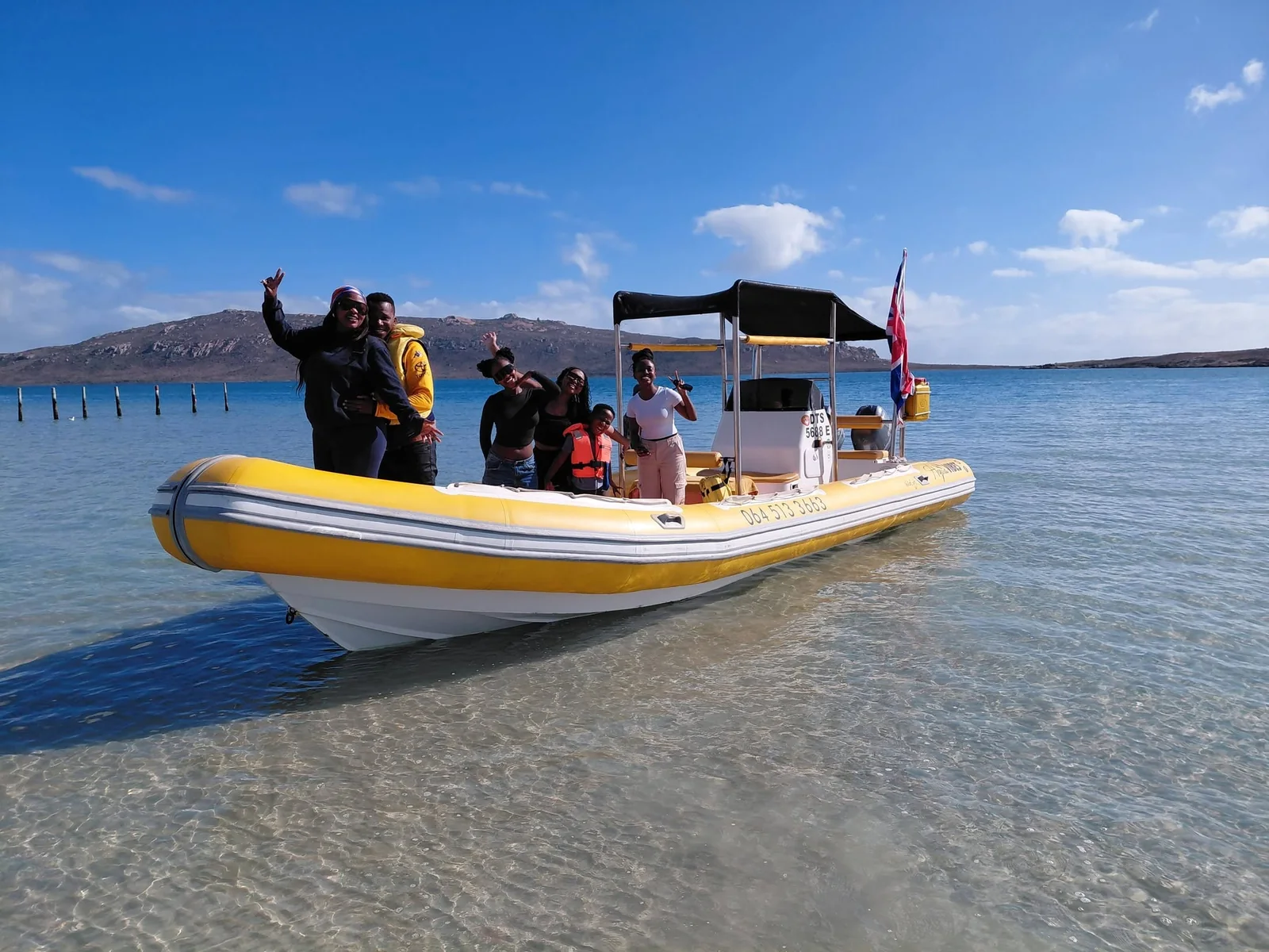 Aqua Vibes guests with the bright yellow boat on Langebaan Lagoon